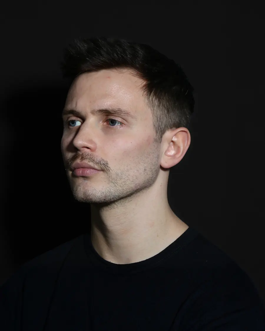 A man photographed at a three-quarter angle showing the jaw line
